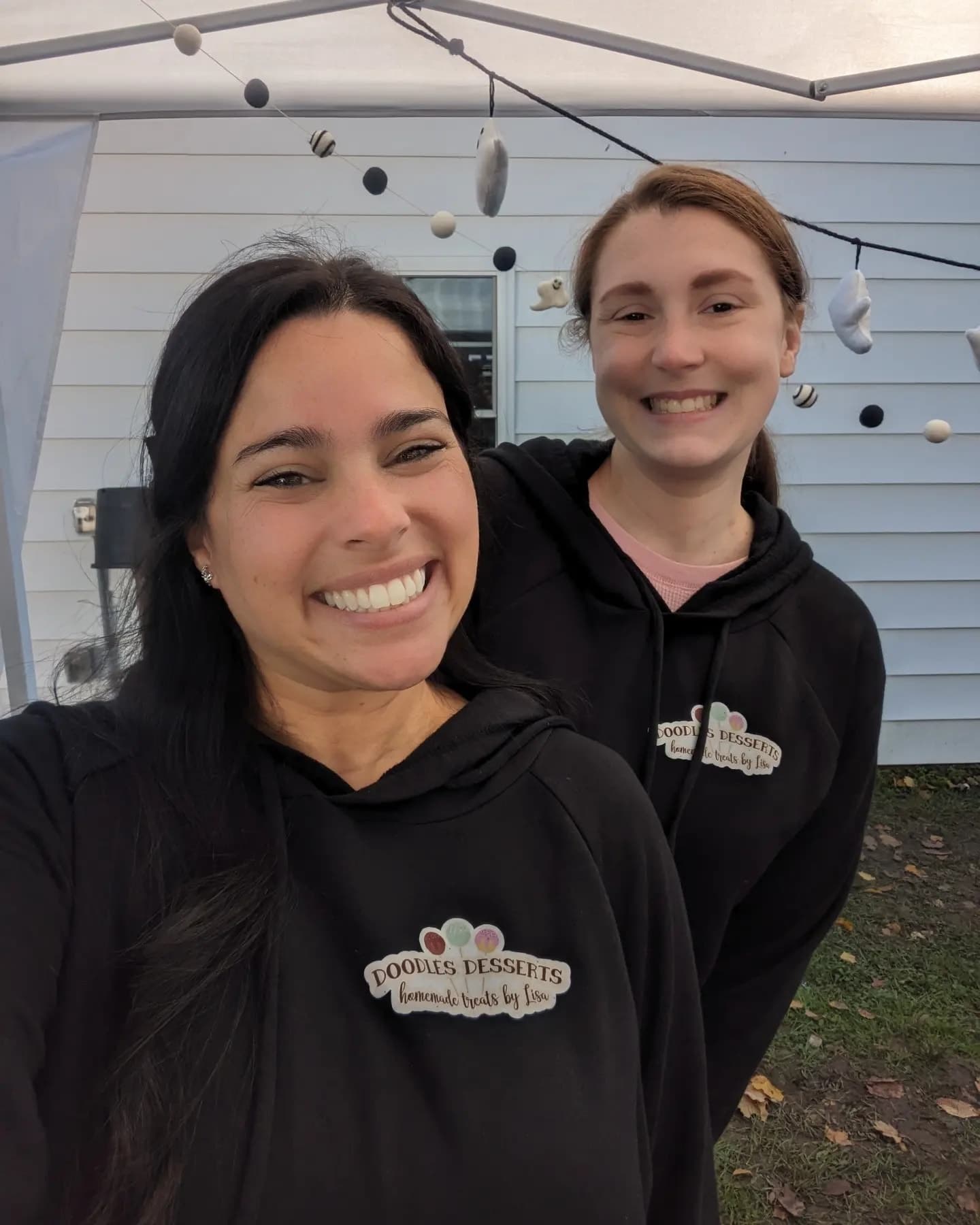 Picture of owner Lisa and friend wearing Doodles Desserts hoodies